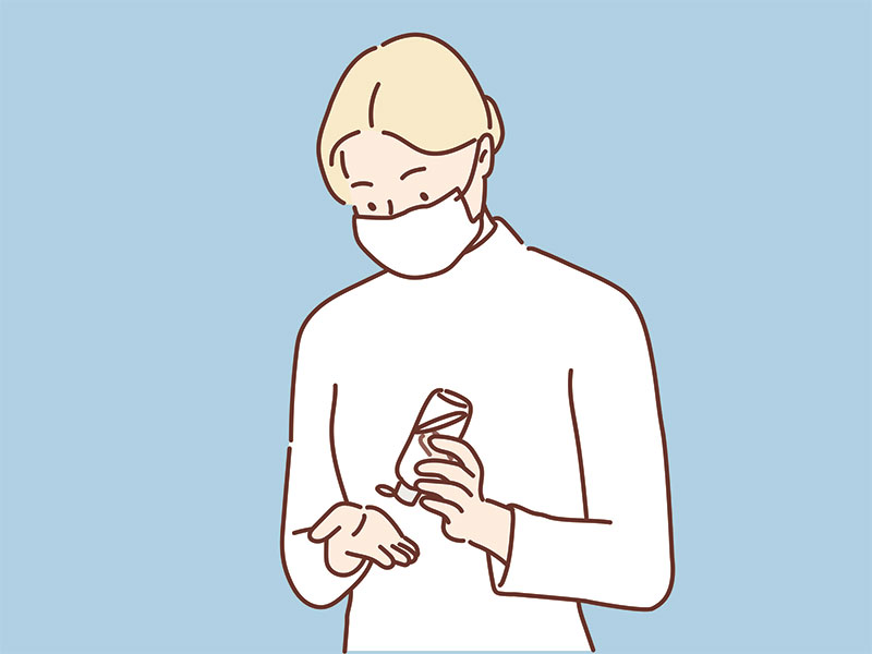 Drawing of someone wearing a face mask and apply hand sanitiser