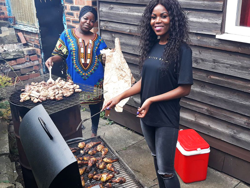 Two women cooking a bbq