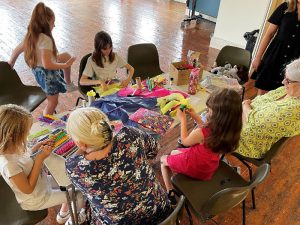 children and adults taking part in craft activities