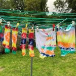 Tie-dyed clothes hanging on a washing line