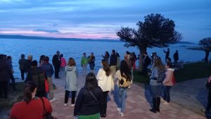 Members of the ECCE conference gathered by a lake in worship.