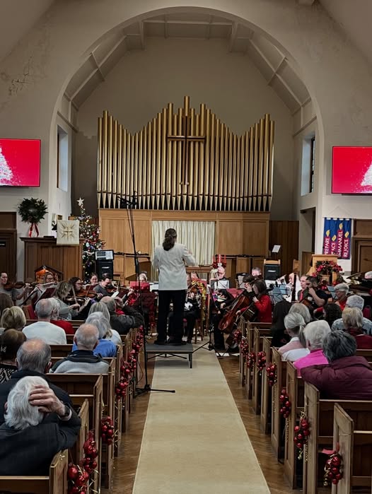 An orchestra playing to a church congregation.