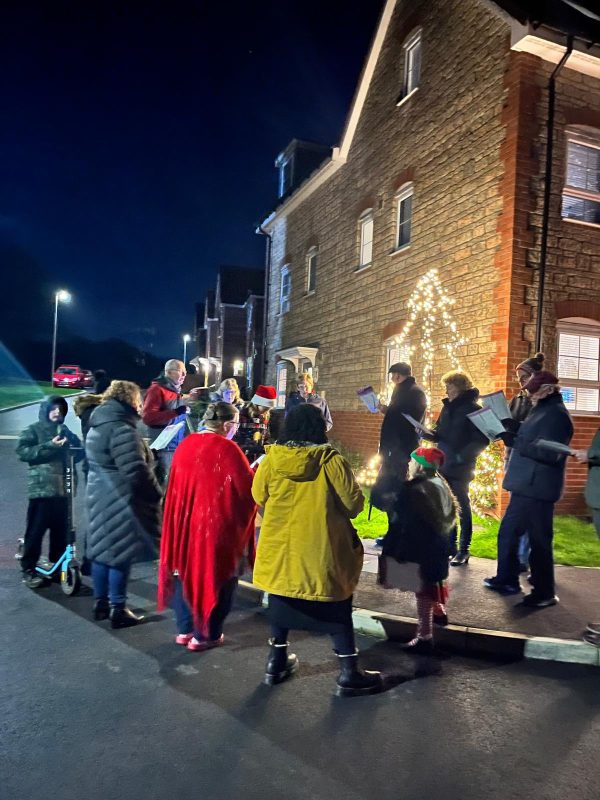 People singing carols on a housing estate.
